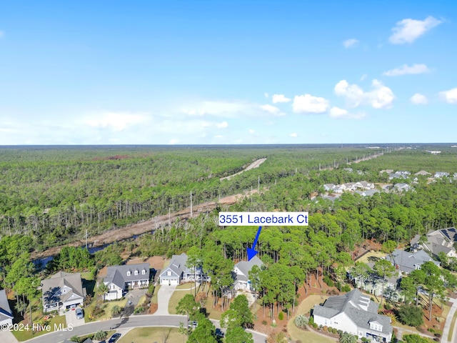 bird's eye view with a wooded view and a residential view