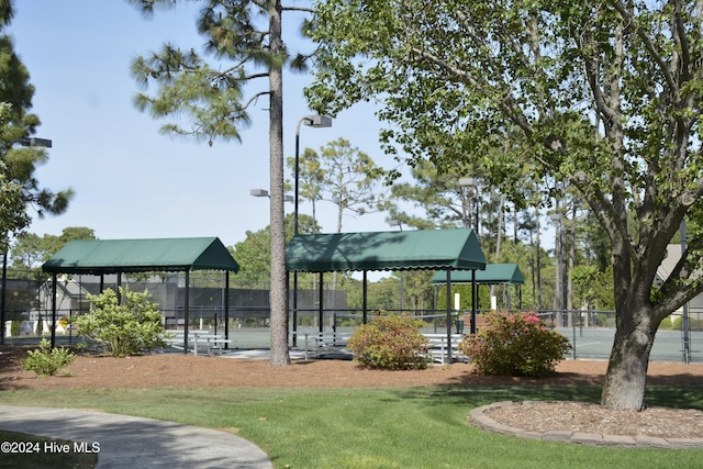 view of home's community with fence and a yard