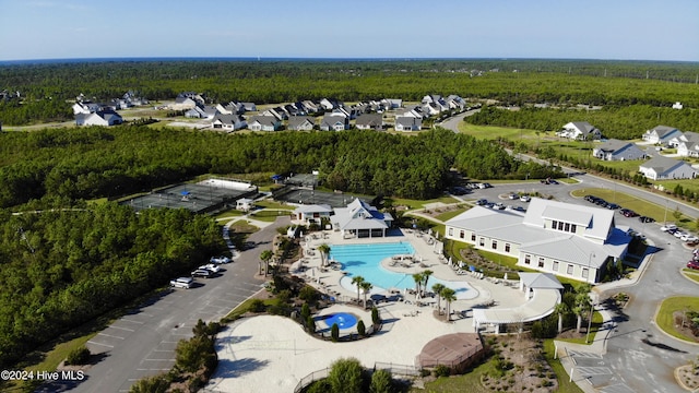 aerial view featuring a wooded view and a residential view