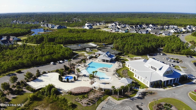 drone / aerial view featuring a forest view and a residential view