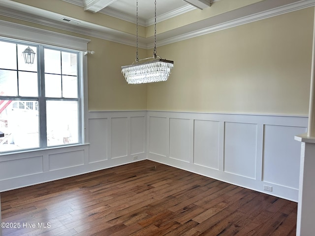 unfurnished dining area with a healthy amount of sunlight, visible vents, dark wood finished floors, and ornamental molding