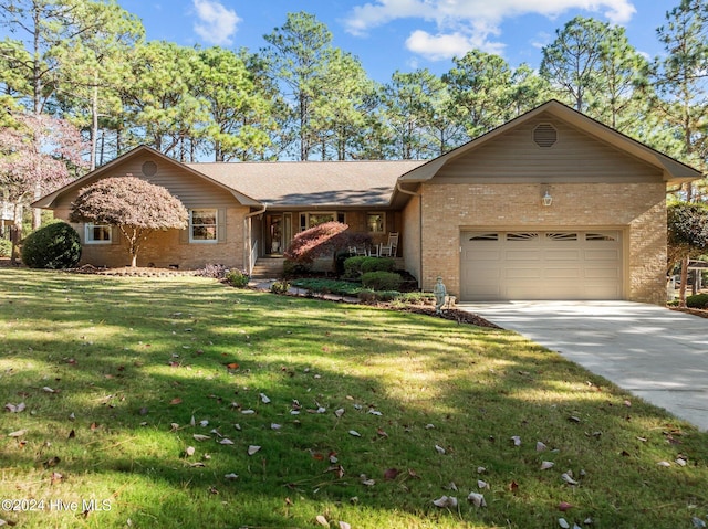 ranch-style house featuring a garage and a front lawn