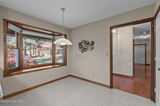 unfurnished dining area with light wood-type flooring