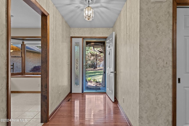 entryway with hardwood / wood-style floors and a textured ceiling