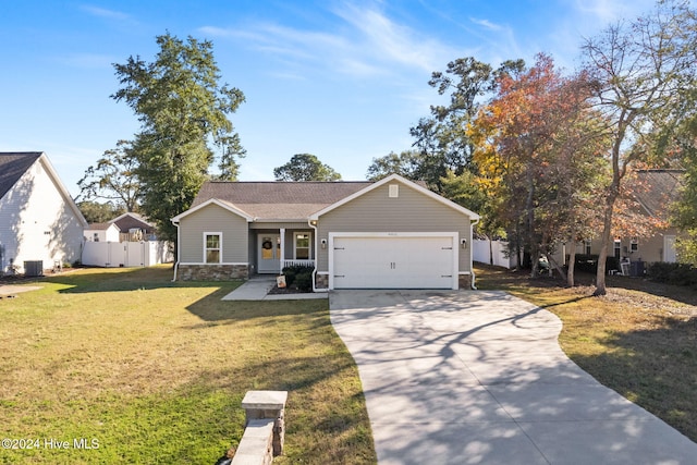 view of front of home with covered porch, a garage, and a front yard