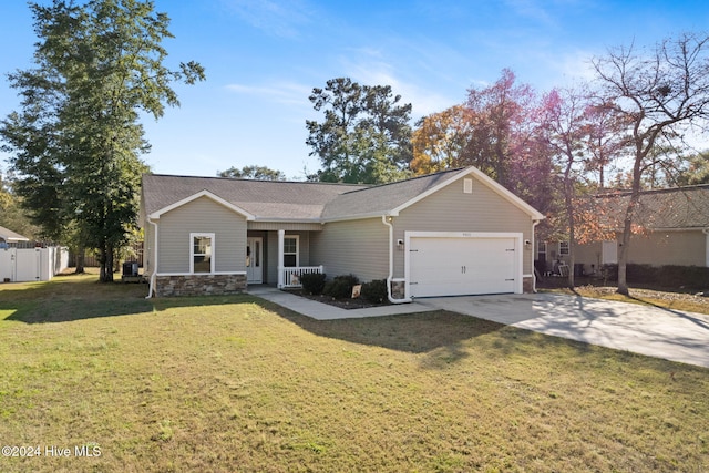 single story home featuring a front yard, a porch, and a garage