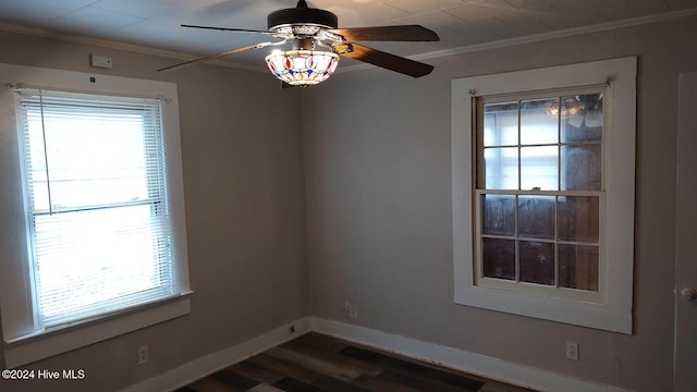 unfurnished room with dark hardwood / wood-style flooring, ceiling fan, and ornamental molding