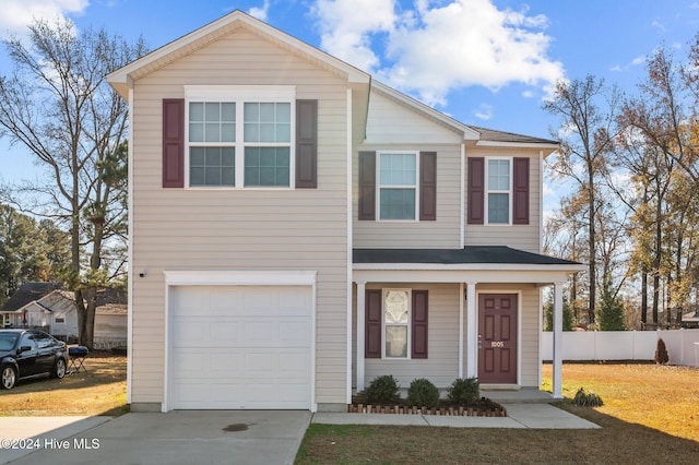 view of front of property featuring a front yard and a garage