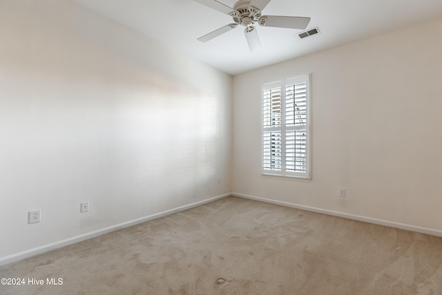 spare room with light carpet and ceiling fan