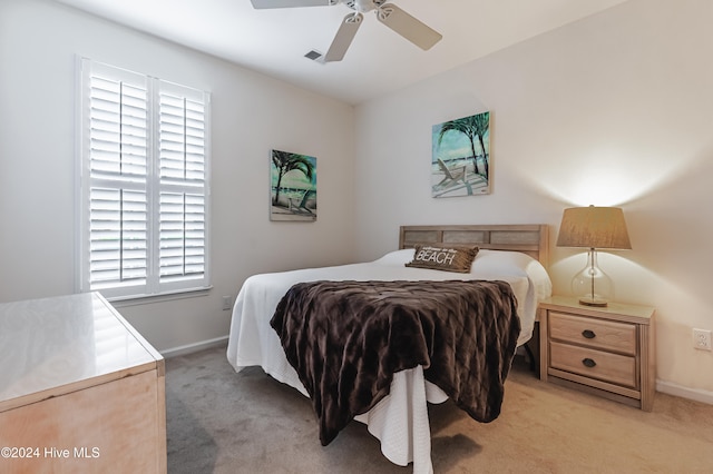 carpeted bedroom with multiple windows and ceiling fan