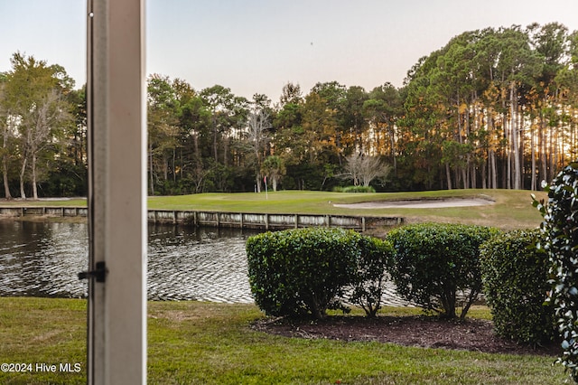 exterior space with a water view and a yard