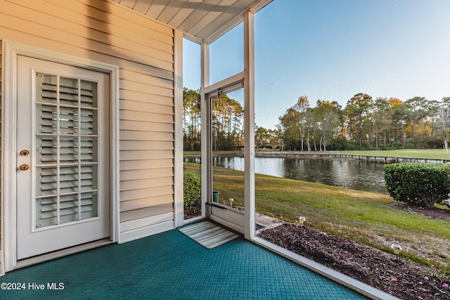 unfurnished sunroom featuring a water view