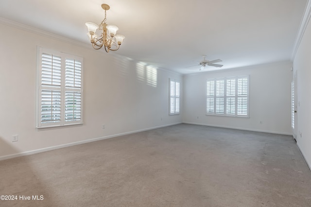 unfurnished room with ceiling fan with notable chandelier, carpet floors, a wealth of natural light, and crown molding