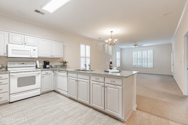 kitchen with white appliances, light colored carpet, white cabinetry, and a wealth of natural light