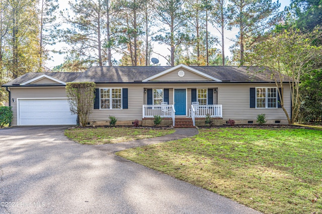 ranch-style house featuring a front yard, a porch, and a garage