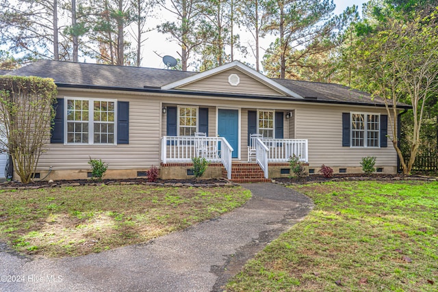 ranch-style home with a porch and a front lawn