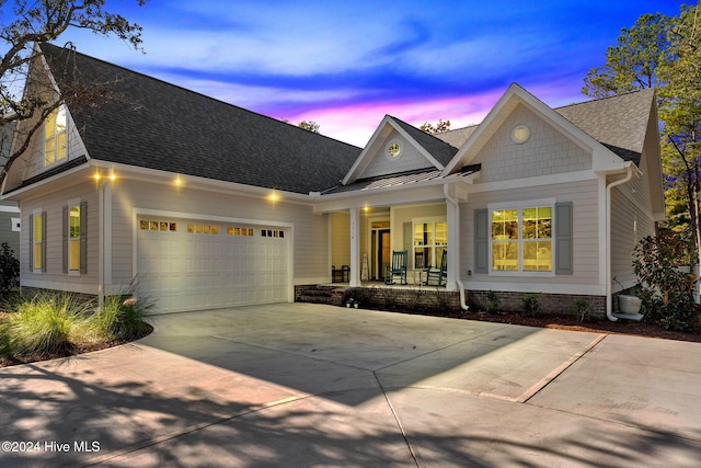 craftsman-style home featuring covered porch and a garage