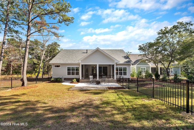 back of house with a sunroom, a yard, and a patio