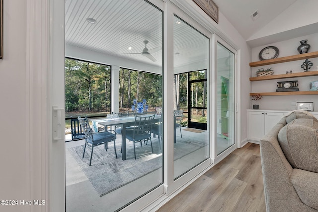 doorway to outside with ceiling fan, light hardwood / wood-style floors, and lofted ceiling