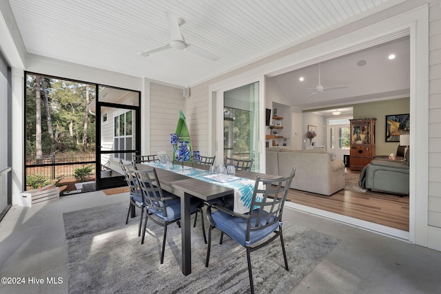 sunroom / solarium featuring lofted ceiling, ceiling fan, and a healthy amount of sunlight