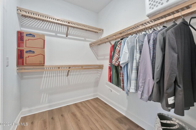 spacious closet with hardwood / wood-style floors