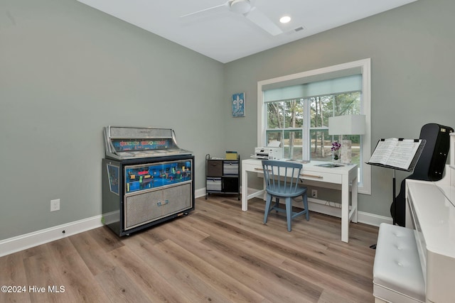 office with light hardwood / wood-style floors and ceiling fan