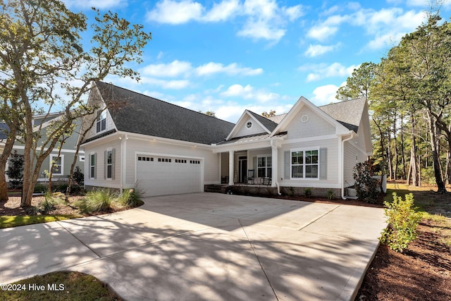 view of front facade featuring a porch and a garage