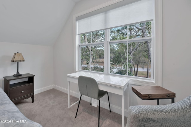 carpeted home office featuring vaulted ceiling