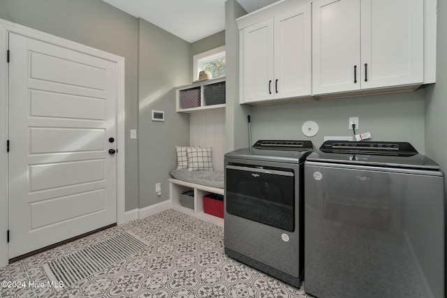 laundry area with cabinets and washer and clothes dryer