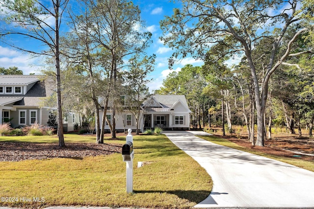 3314 Four Water Ln SW, Supply, NC 28462 - modern farmhouse featuring driveway, a standing seam roof, a front yard, and metal roof
