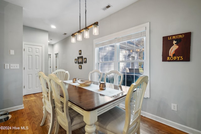 dining space with hardwood / wood-style floors