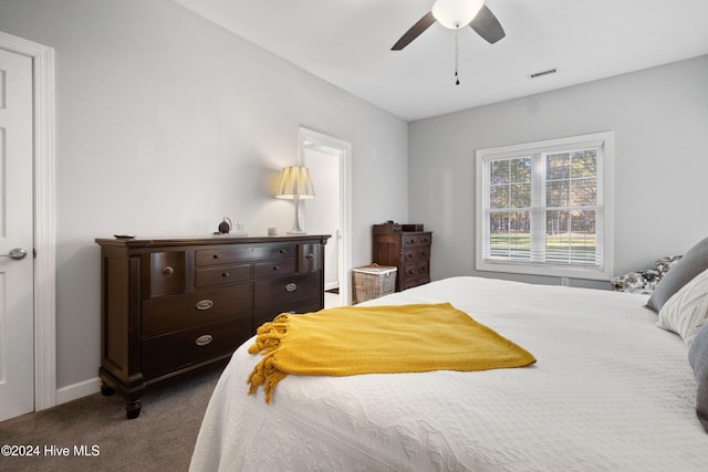 bedroom featuring ceiling fan and dark colored carpet