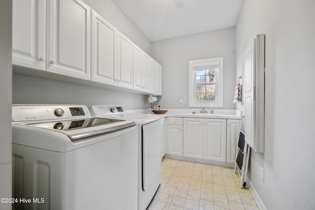 laundry room featuring cabinets, independent washer and dryer, and sink