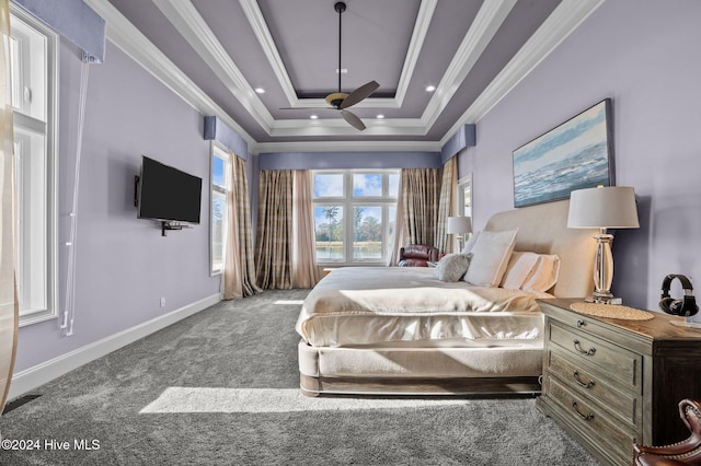 bedroom with a raised ceiling, crown molding, carpet, and ceiling fan