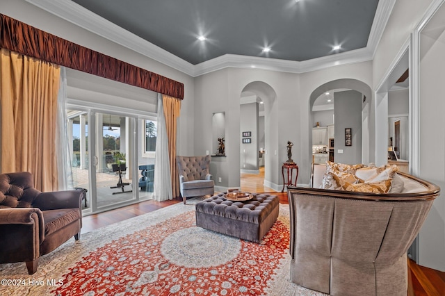 living room featuring crown molding and light hardwood / wood-style floors