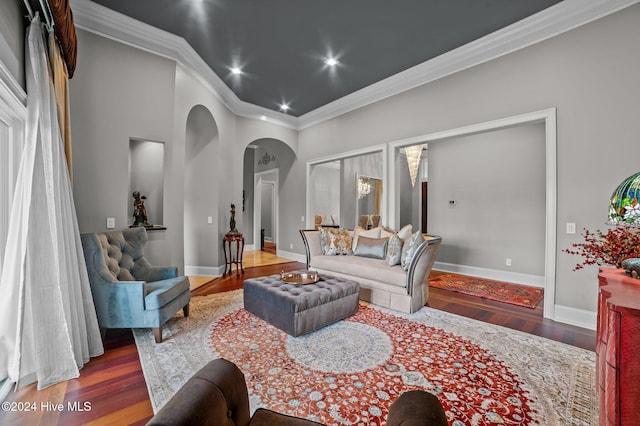 living room featuring crown molding and dark wood-type flooring