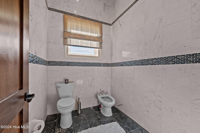 bathroom featuring a bidet, tile walls, and toilet