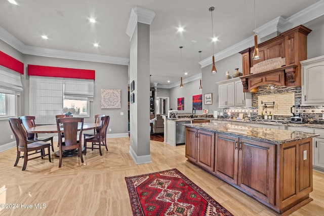 kitchen with pendant lighting, decorative backsplash, ornamental molding, and stainless steel appliances