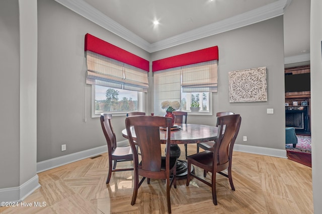 dining room with crown molding and light parquet flooring