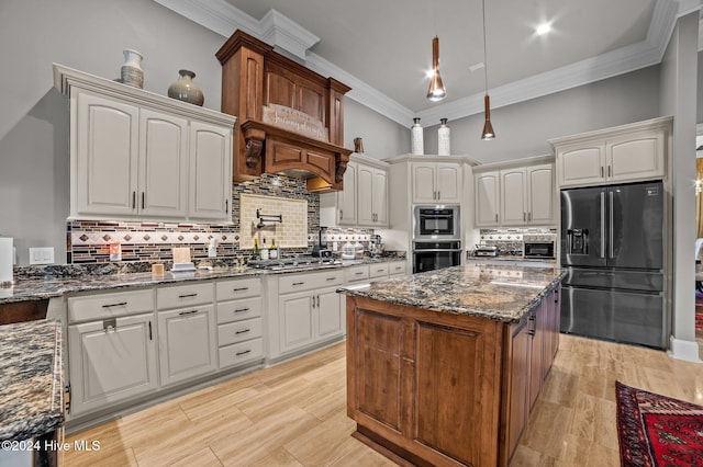 kitchen with dark stone countertops, white cabinetry, and stainless steel appliances