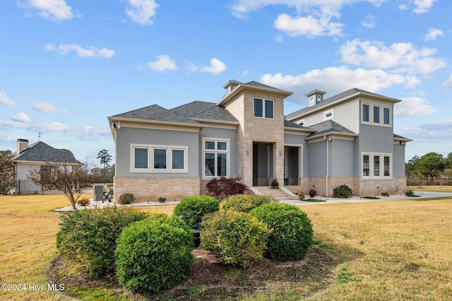 view of front facade with central AC and a front lawn