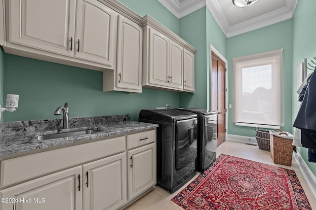 washroom featuring sink, cabinets, washing machine and dryer, crown molding, and light tile patterned flooring