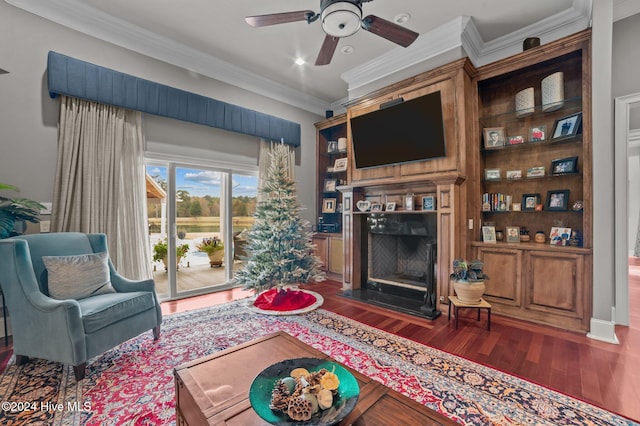 living room with dark hardwood / wood-style flooring, ceiling fan, and crown molding