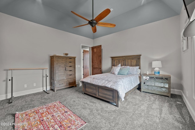 carpeted bedroom featuring vaulted ceiling and ceiling fan