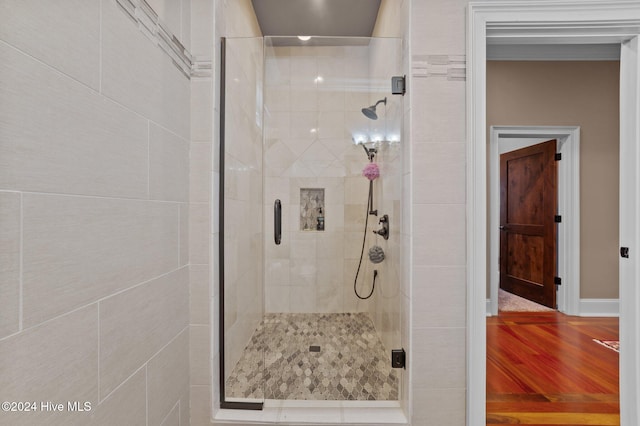 bathroom featuring wood-type flooring and walk in shower