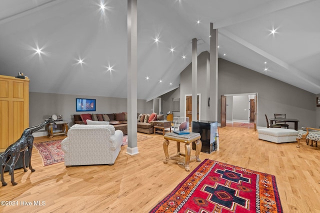 living room with beamed ceiling, wood-type flooring, and high vaulted ceiling