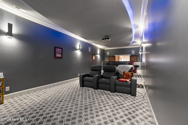 carpeted cinema room with ornamental molding