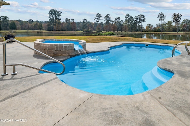 view of swimming pool featuring pool water feature, a water view, and a patio area