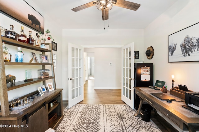 office with ceiling fan, light hardwood / wood-style floors, and french doors