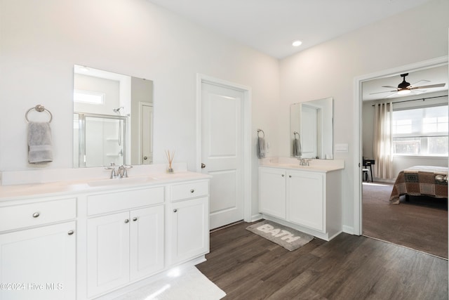 bathroom featuring walk in shower, hardwood / wood-style floors, vanity, and ceiling fan